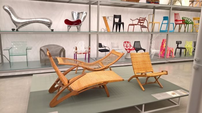 The JH512 folding chair (r.), JH511 Long Dolphin Chair (front) & GE2 Hammock lounger (rear), as seen at Hans J. Wegner: Designing Danish Modern. Vitra Design Museum Schaudepot 