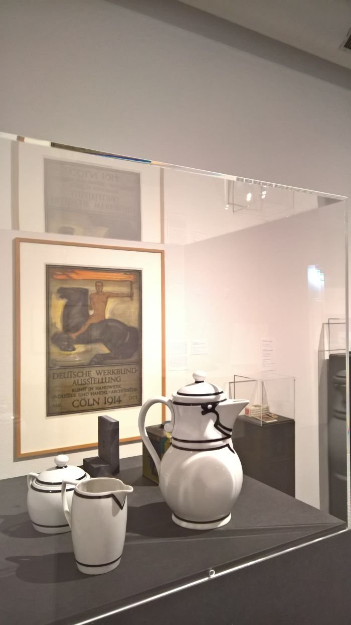 Coffee pot, milk jug and sugar bowl for Kaiser's Berlin and Behrens poster for the 1914 Werkbund exhibition in Cologne, as seen at Peter Behrens. #all-rounder, the Museum für Angewandte Kunst Cologne