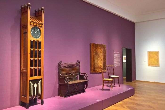 A Longcase Clock Chris Wegerif & bench by Johan Thorn Prikker, all for Arts & Crafts, chairs by Henry van de Velde & Johan Thorn Prikker, as seen at Art Nouveau in Nederland, The Gemeentemuseum Den Haag