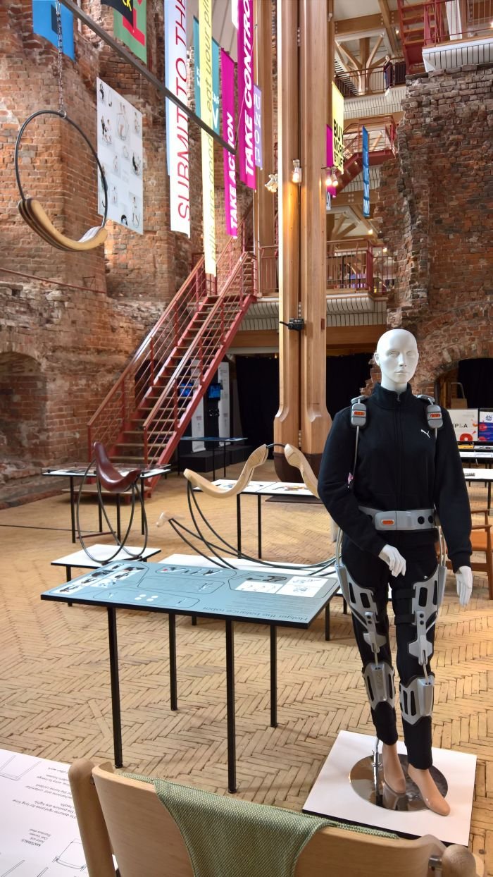 Holger the balance robot wearable exoskeleton by Hans Christian Falkenberg-Hansen and in the background A workout for the body by Signe Lindberg Lemche, as seen at Designer, grib magten! Design School Kolding 2018 graduation exhibition, Koldinghus