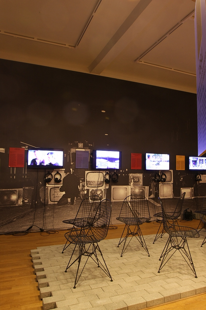 A collection of films, and Eames Wire Chairs, as seen at Together. The new architecture of the collective the Grassi Museum für Angewandte Kunst Leipzig