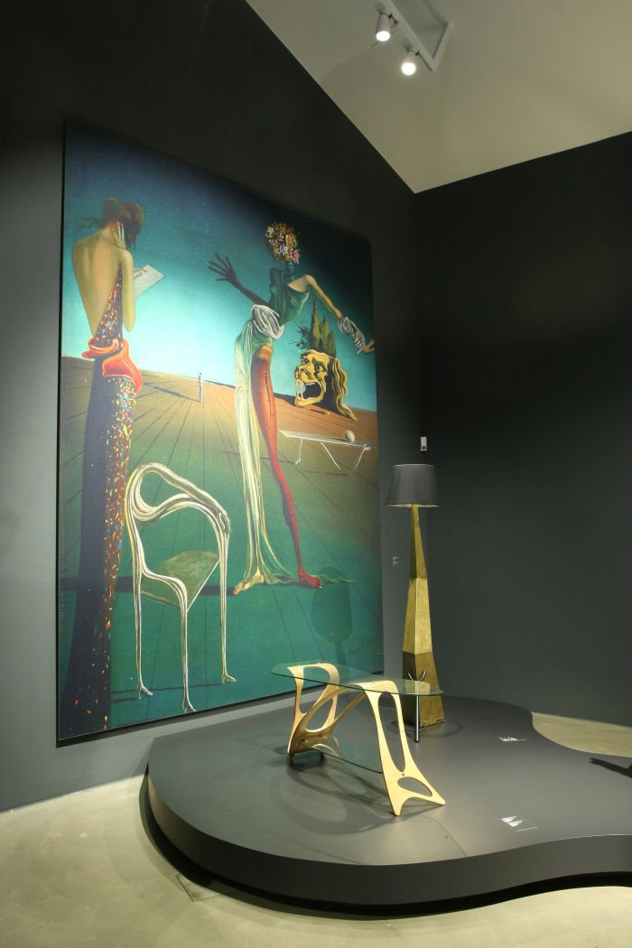 A blow-up of the painting Femme à la tête de roses by Salvador Dalí alongside Arabesco by Carlo Mollino and the lamp Bracelli by Salvador Dalí, as seen at Objects of Desire. Surrealism and Design 1924 - Today, Vitra Design Museum