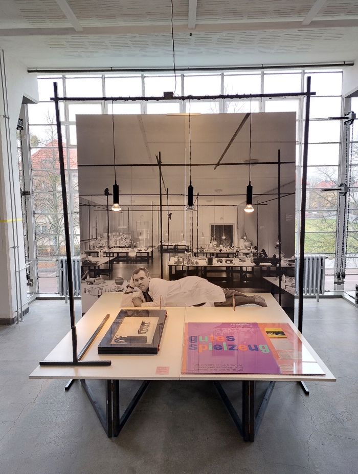 Otl Aicher relaxing on the Gutes Spielzeug exhibition stand system, as seen at HfG Ulm: Exhibition Fever, Bauhaus Building, Dessau