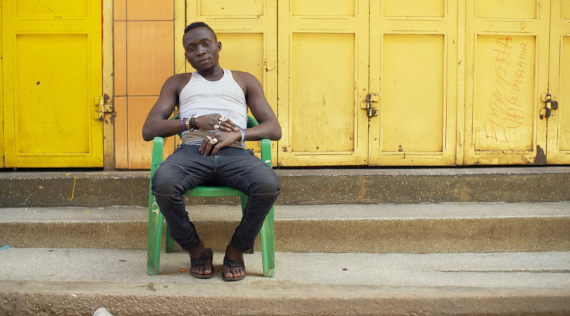 A young man in Kampala, Uganda. On a monobloc. (Photo © Boris Mahlau / PIER 53, courtesy Hatje Cantz)