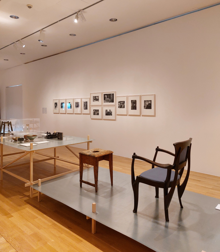 A truly joyous stool by Richard Riemerschmid (l) and an armchair by Berhard Pankok (r) in front of portraits from Heidi Vogel-Hennig's series "The Last of Their Profession", as seen at Craft as Myth. Between Ideal and Real Life, Museum Angewandte Kunst, Frankfurt