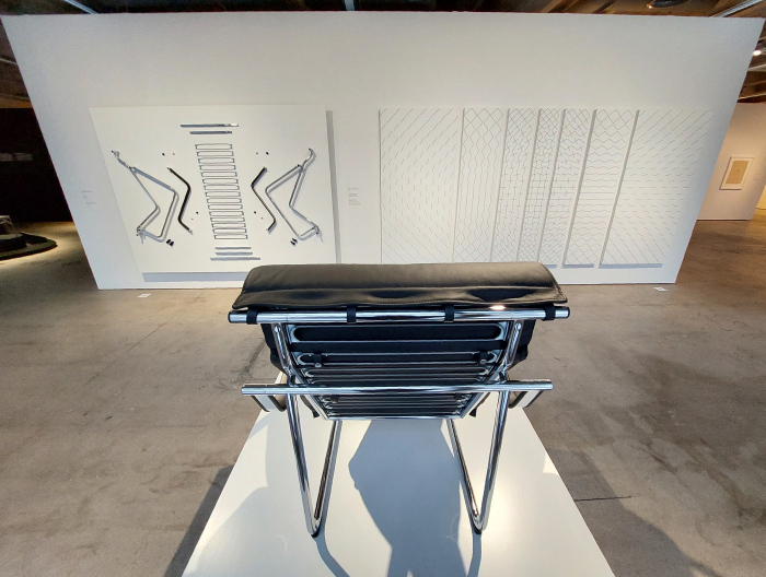 The Remmi lounge chair by Yrjö Kukkapuro enjoying Kukkapuro's relief of the component parts and 7-osainen maalaus by Matti Kujasalo, as seen at Yrjö Kukkapuro - Magic Room, Espoo Museum of Modern Art, EMMA