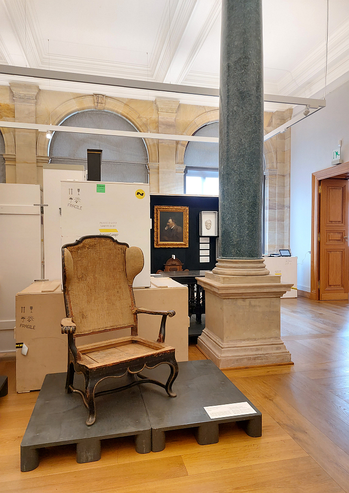 Friedrich Nietzsche's wingbacked armchair watched over by the man himself, as seen in Nietzsche Privat, Neues Museum Weimar. Part of the Klassik Stiftung Weimar's Theme Year 2023: Wohnen