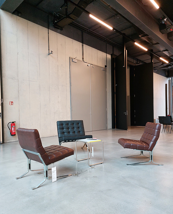 A plagiarism of the Barcelona chair by Ludwig Mies van der Rohe (m) in dialogue with two Conferstar chairs by Rudolf Horn (although we're questioning if they are Conferstars, we don't believe they are), in the Bauhaus Museum Dresden, as seen in context of Mehr als echt (More than real) by Jun Yang, Stiftung Bauhaus Dessau