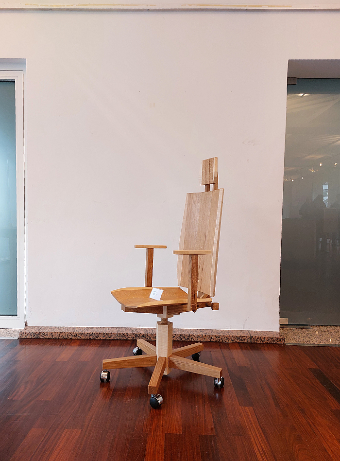 A wooden office chair by Aron Rudi Šipak as seen in the Handwerkskammer zu Köln during Passagen Interior Design Week Cologne 2025