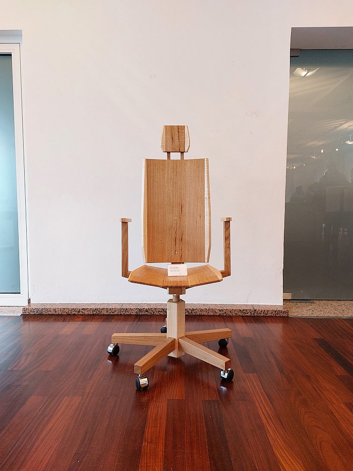 A wooden office chair by Aron Rudi Šipak as seen in the Handwerkskammer zu Köln during Passagen Interior Design Week Cologne 2025