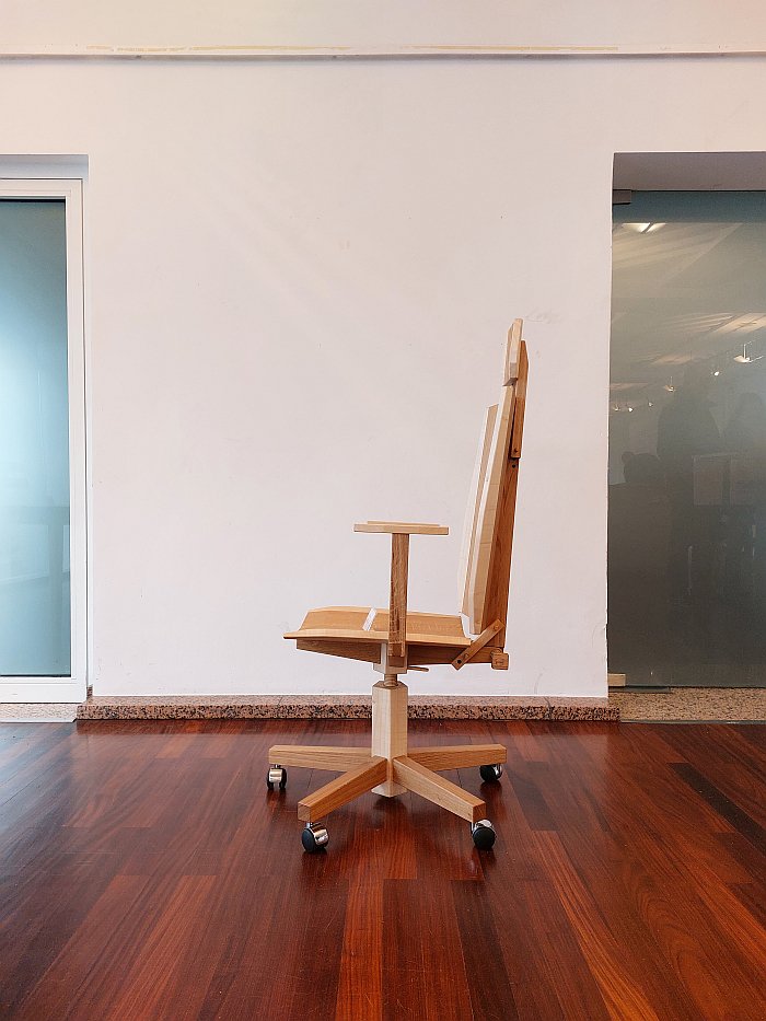 A wooden office chair by Aron Rudi Šipak as seen in the Handwerkskammer zu Köln during Passagen Interior Design Week Cologne 2025