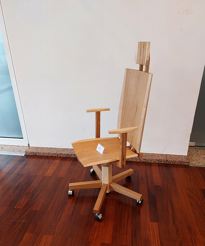 A wooden office chair by Aron Rudi Šipak as seen in the Handwerkskammer zu Köln during Passagen Interior Design Week Cologne 2025