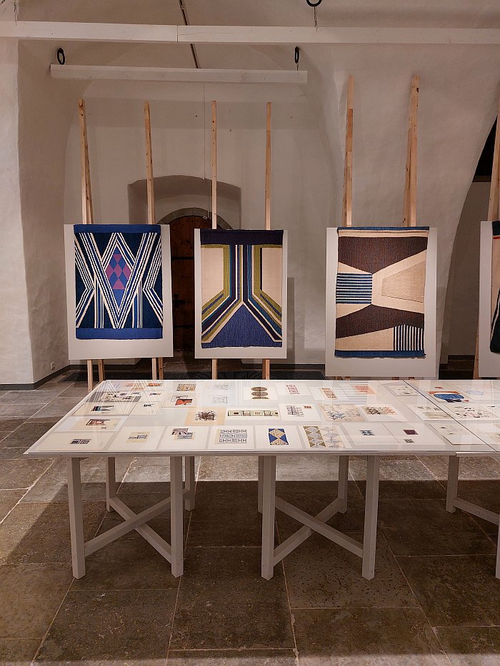 A table with sketches and cuttings by Bruno Tomberg from his travels, and rugs from his Perspectives collection, as seen at Bruno Tomberg. Inventing Design, Estonian Museum of Applied Art and Design, Tallinn